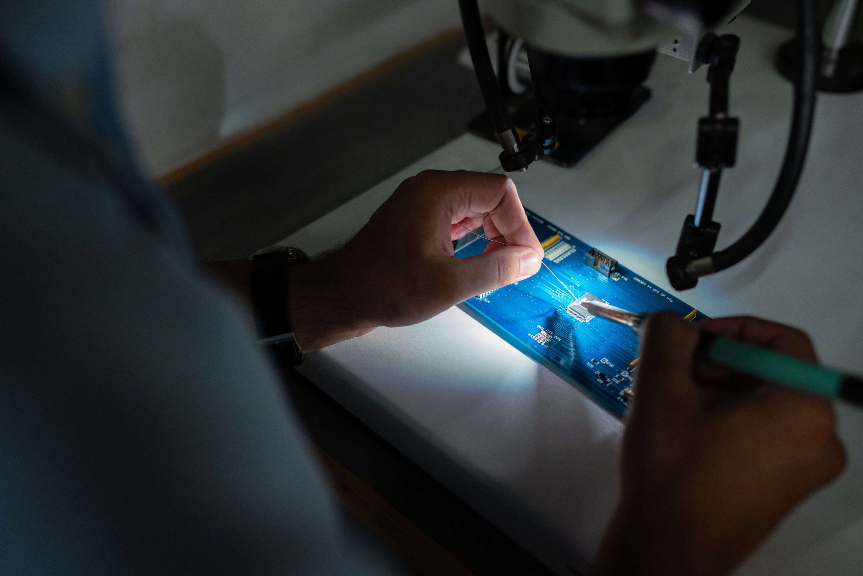 man-soldering-computer-chip